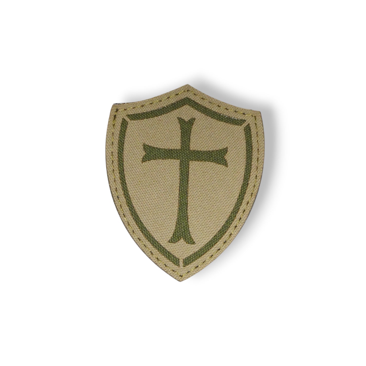 Beige shield patch with green cross on a white background