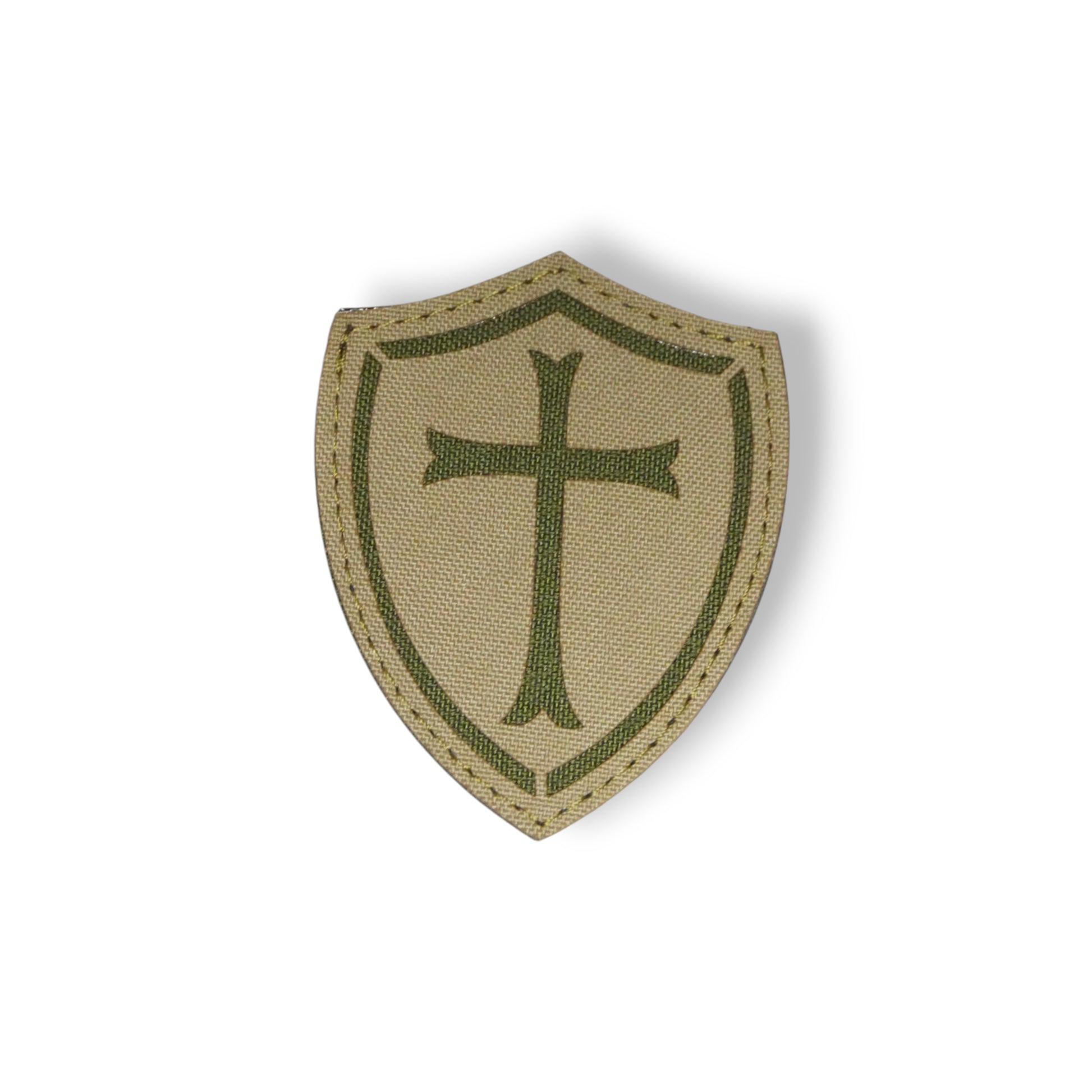 Beige shield patch with green cross on a white background