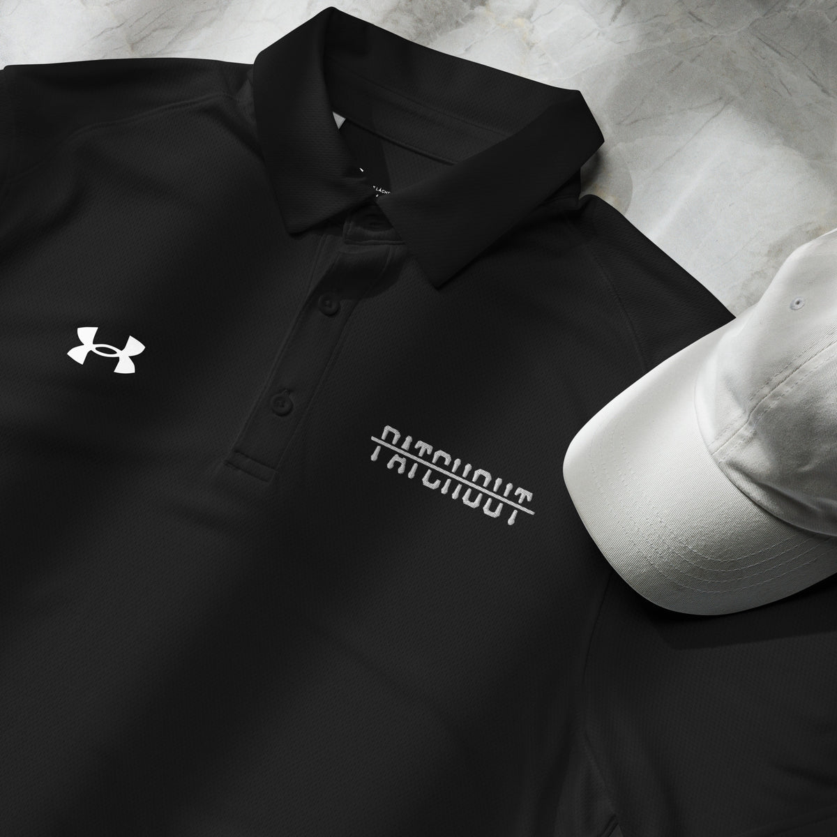 The Company polo, Patch Out and Under Armour logos